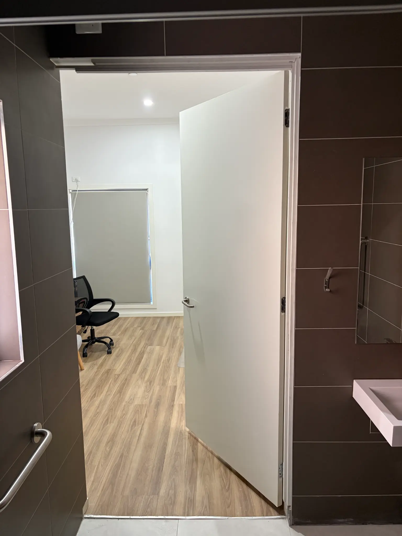 Completed bathroom renovation viewed through the doorway