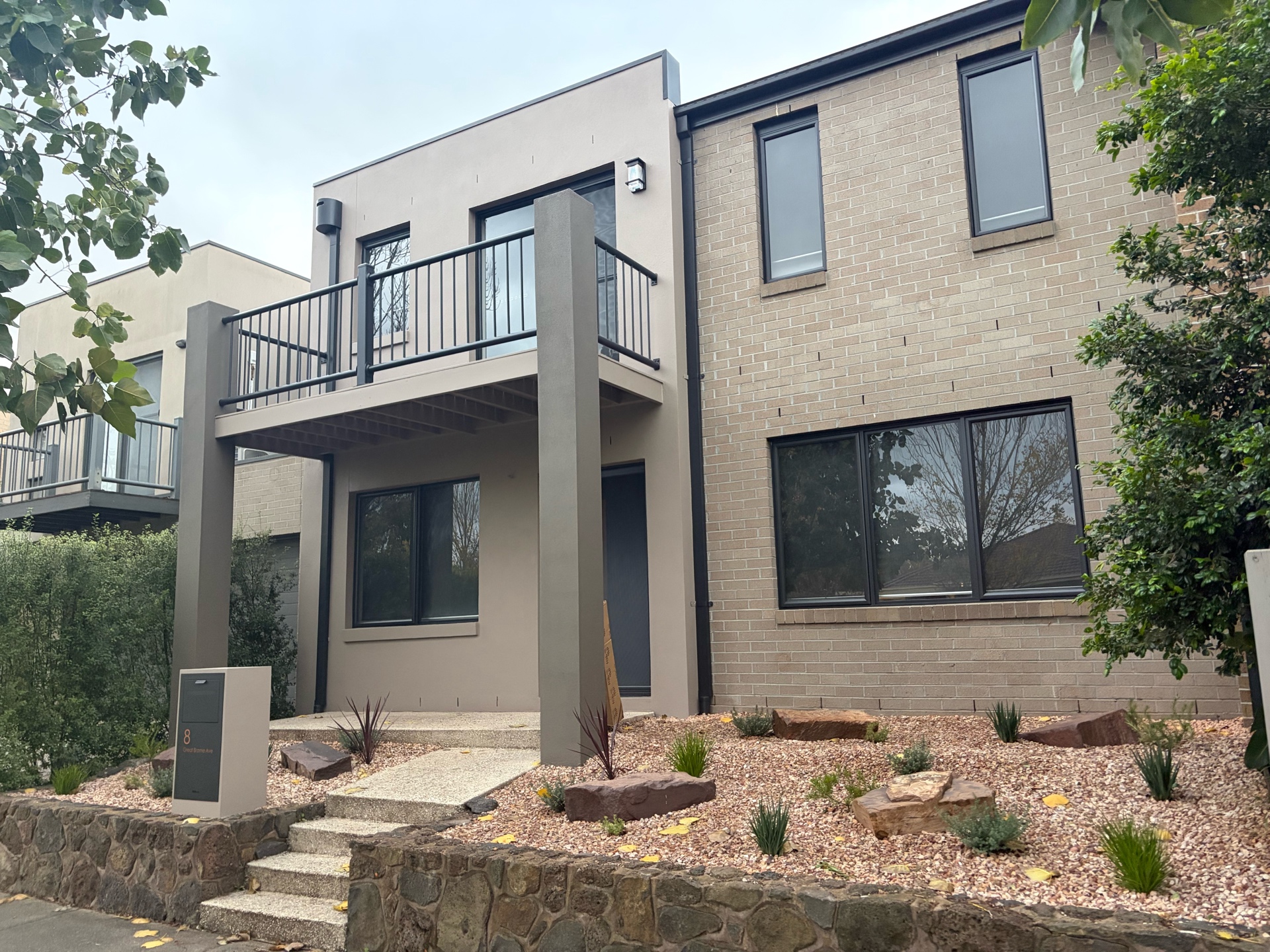 Completed home renovation exterior with rendered facade and landscaping, Melbourne