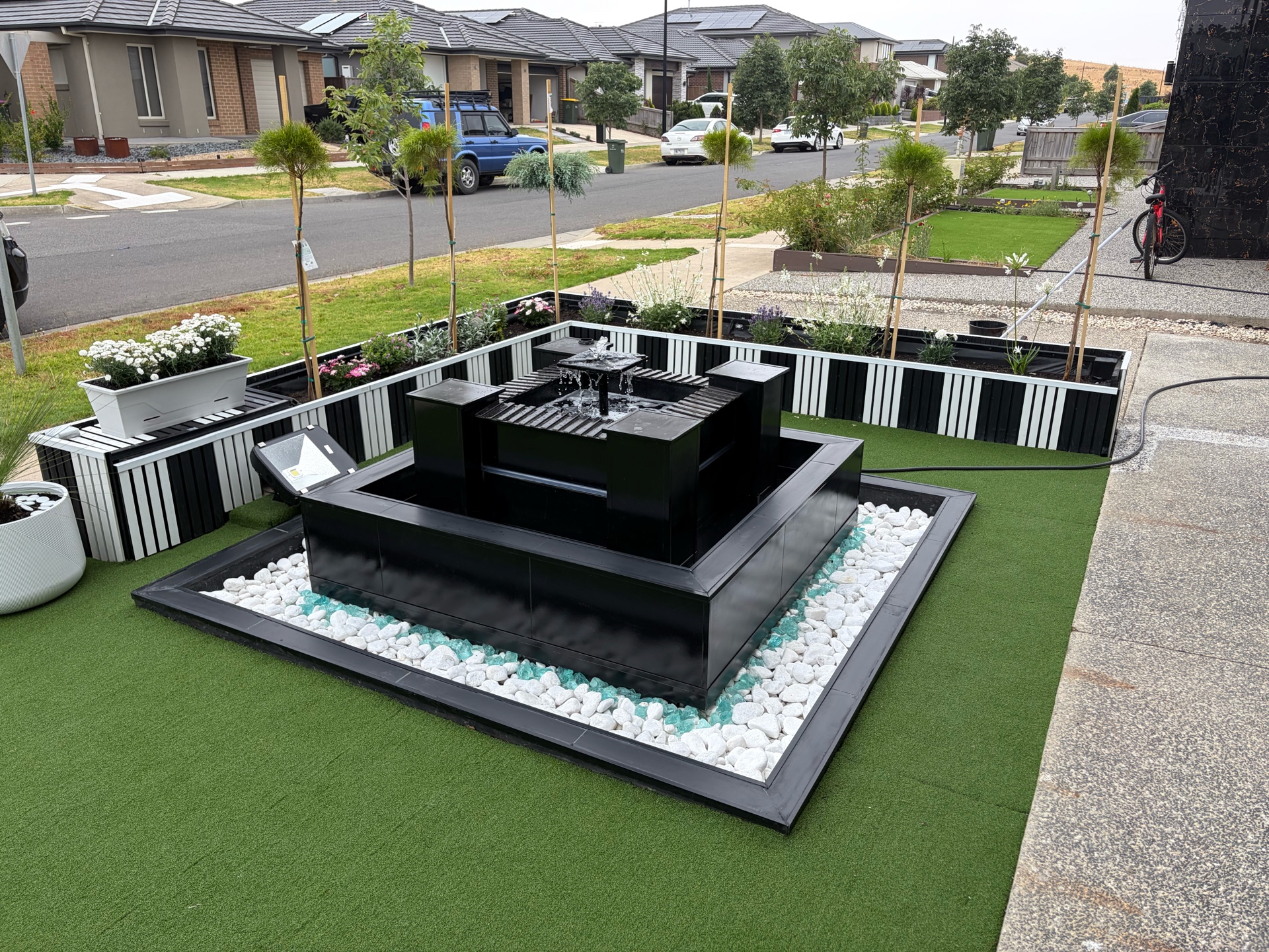 Tiered water feature with white pebbles and glass chips, Melbourne landscaping project